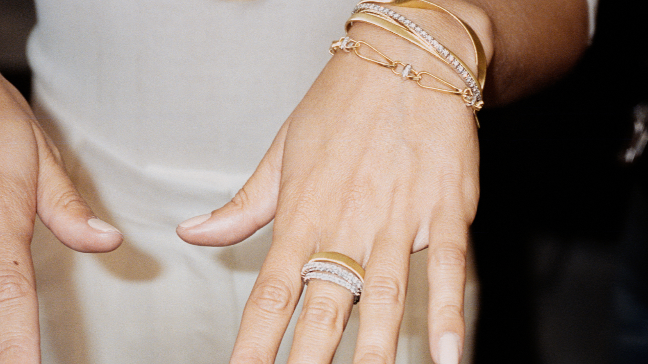 Woman showing Marco Bicego rings and bracelets on her hands. Photo is event cover for H&H Jewels vendor spotlight in Miami Florida